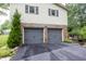 Attached two-car garage with gray doors, brick accents, and a well-maintained asphalt driveway at 2457 N Centerline Rd, Franklin, IN 46131