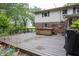 Wooden deck features a hot tub with mature trees and a glimpse of a grassy field at 2457 N Centerline Rd, Franklin, IN 46131