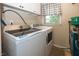 Well-equipped laundry room featuring a front-loading washer and dryer with a window for natural light at 2457 N Centerline Rd, Franklin, IN 46131