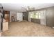 Spacious living room with neutral decor, plush carpeting, large windows and staircase to second level at 2457 N Centerline Rd, Franklin, IN 46131