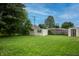 Large backyard featuring storage sheds, mature trees, and plenty of green space at 2620 13Th St, Columbus, IN 47201