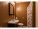 Modest bathroom featuring a sink, toilet, mirror, and shower with patterned curtain at 2620 13Th St, Columbus, IN 47201
