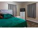 Cozy bedroom featuring bright bedding, a white dresser, decorative pillows, and soft window lighting at 2620 13Th St, Columbus, IN 47201