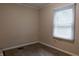 Modest bedroom features neutral walls, carpeted floors, and natural light from the window at 2620 13Th St, Columbus, IN 47201
