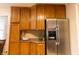 Kitchen space with stainless steel refrigerator, plentiful wood cabinets, and well-lit countertops at 2620 13Th St, Columbus, IN 47201