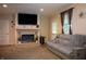 Relaxing living room featuring a brick fireplace, large TV, and comfortable seating with natural light at 2620 13Th St, Columbus, IN 47201