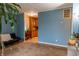 Inviting living room featuring plush carpet, blue walls, and seamless access to the adjacent kitchen at 2620 13Th St, Columbus, IN 47201