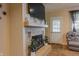 Cozy living room features a classic brick fireplace, a large television, and comfortable seating at 2620 13Th St, Columbus, IN 47201