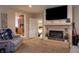 Comfortable living room with brick fireplace, modern TV, and cozy access to the kitchen and bedroom at 2620 13Th St, Columbus, IN 47201