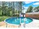 Backyard featuring an above ground pool, wooden deck, outbuildings, and mature trees at 2907 Jay Dee Ln, Greenwood, IN 46143