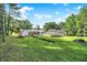 Expansive backyard featuring a pool, trampoline, various buildings, and lush greenery at 2907 Jay Dee Ln, Greenwood, IN 46143