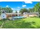 Large backyard featuring an above ground pool, mature trees, a deck and additional outbuildings at 2907 Jay Dee Ln, Greenwood, IN 46143