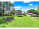 Large backyard including outbuildings, mature shade trees, and an above-ground pool with deck at 2907 Jay Dee Ln, Greenwood, IN 46143