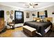 Cozy bedroom with hardwood floors, ceiling fan, wooden furniture, and stylish decor accents at 2907 Jay Dee Ln, Greenwood, IN 46143