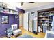 Organized bedroom with purple accent wall, closet shelving, and comfortable seating at 2907 Jay Dee Ln, Greenwood, IN 46143