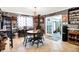 Charming dining room features a rustic table set, decorative lighting, and backyard access at 2907 Jay Dee Ln, Greenwood, IN 46143