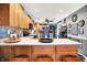 Spacious kitchen featuring wood cabinetry, stainless steel appliances, and an open layout to the living area at 2907 Jay Dee Ln, Greenwood, IN 46143