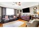 Cozy living room features hardwood floors, a ceiling fan, and comfortable leather seating at 2907 Jay Dee Ln, Greenwood, IN 46143