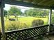 Scenic backyard view with a swing, pond and lush green grass visible from the back porch at 317 W State Road 44, Franklin, IN 46131