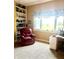 Cozy bedroom with built-in shelves, a comfy reading chair and a view of the yard at 317 W State Road 44, Franklin, IN 46131