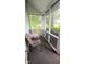 Relax on this screened porch with chairs and a table and view of green space at 317 W State Road 44, Franklin, IN 46131