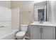 Stylish bathroom with updated vanity, grey cabinets, modern sink, and tub with white tile surround at 3351 Summer Breeze Cir, Indianapolis, IN 46239