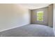 Neutral bedroom with gray carpet and a window providing natural light and a view of lush greenery outside at 3351 Summer Breeze Cir, Indianapolis, IN 46239