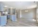 Open kitchen featuring stainless steel appliances, light blue cabinets, and modern wood-look flooring at 3351 Summer Breeze Cir, Indianapolis, IN 46239