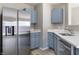 Charming kitchen featuring stainless steel appliances, blue cabinets, and a modern sink at 3351 Summer Breeze Cir, Indianapolis, IN 46239