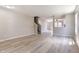 Open living room boasts modern wood-look floors, neutral paint, and seamless flow to other spaces at 3351 Summer Breeze Cir, Indianapolis, IN 46239