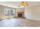 Inviting living room features a cozy stone fireplace, modern flooring, and a ceiling fan at 3351 Summer Breeze Cir, Indianapolis, IN 46239