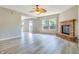 Spacious living area with modern wood-look floors, fireplace, and seamless transition to the outdoors at 3351 Summer Breeze Cir, Indianapolis, IN 46239