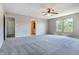Spacious main bedroom with neutral carpet, ceiling fan, and abundant natural light from large windows at 3351 Summer Breeze Cir, Indianapolis, IN 46239