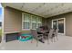 Covered back patio with a dining area and outdoor grill, offering the perfect space for entertaining at 3599 Chalmers Dr, Bargersville, IN 46106