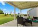 Enjoy the outdoors on this home's covered patio featuring a dining area and views of the backyard at 3599 Chalmers Dr, Bargersville, IN 46106