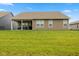 Expansive backyard with lush green grass and a covered patio, perfect for outdoor activities at 3599 Chalmers Dr, Bargersville, IN 46106