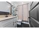 Neutral bath with single sink vanity, decorative shelving and woodland themed shower curtain at 3599 Chalmers Dr, Bargersville, IN 46106