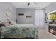 A cozy bedroom features a floral bedspread and a fireplace with a mounted TV at 3599 Chalmers Dr, Bargersville, IN 46106