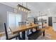 Bright dining area featuring a wooden table with black accents and natural light at 3599 Chalmers Dr, Bargersville, IN 46106