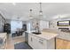 Open concept kitchen features island, stainless appliances, seamlessly blending with dining and living areas at 3599 Chalmers Dr, Bargersville, IN 46106