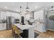Modern kitchen features stainless steel appliances, center island with countertop seating, and sleek white cabinets at 3599 Chalmers Dr, Bargersville, IN 46106