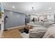 Bright and airy living room featuring an open layout, modern furnishings, and wood-look flooring at 3599 Chalmers Dr, Bargersville, IN 46106