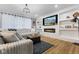 Comfortable living room featuring a modern fireplace, built-in shelves, and wood-look flooring at 3599 Chalmers Dr, Bargersville, IN 46106