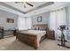 Serene main bedroom featuring a tray ceiling, hardwood furniture, and plush carpet at 3599 Chalmers Dr, Bargersville, IN 46106