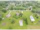 An aerial view of a home with large grassy yard, other buildings, and mature trees in a residential neighborhood at 391 W 500 S, Anderson, IN 46013