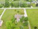 Expansive aerial view of home with a large yard, mature trees, and a long driveway leading to the residence at 391 W 500 S, Anderson, IN 46013