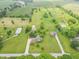 Stunning aerial view of a home situated on a vast, lush green property with multiple outbuildings at 391 W 500 S, Anderson, IN 46013