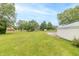 Expansive backyard featuring lush greenery and mature trees offering ample space and privacy at 391 W 500 S, Anderson, IN 46013