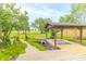 Beautiful backyard featuring a covered area, walkway, landscaping, and expansive lawn at 391 W 500 S, Anderson, IN 46013