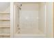 Clean white bathroom with a tub and shower combo plus built-in wall shelving at 391 W 500 S, Anderson, IN 46013
